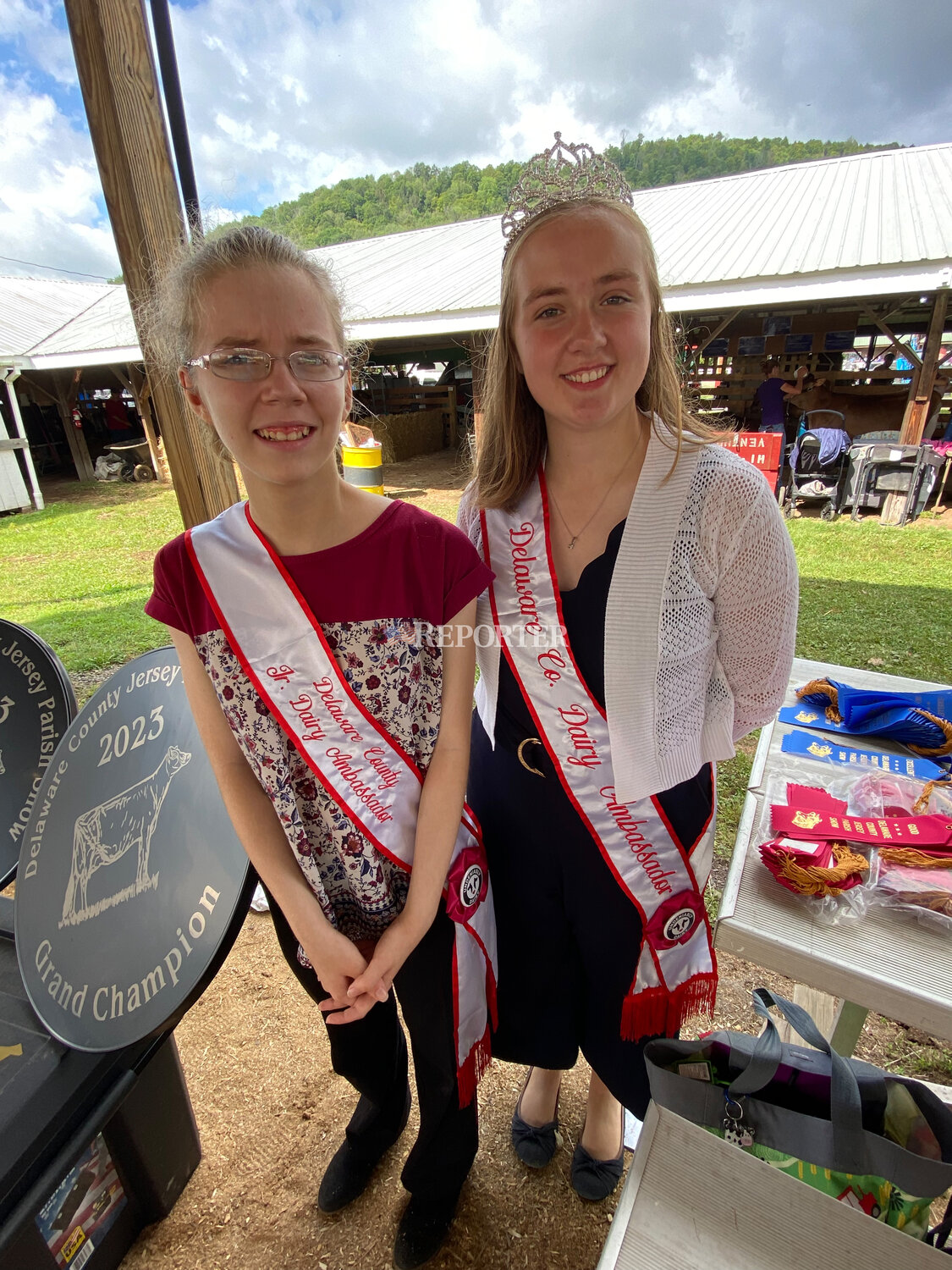 The 2022-23 Dairy Ambassador Jessica Coleman and Junior Dairy Ambassador Angela Cerosaletti present ribbons at Sunday’s open Jersey Parish Show at the Delaware County Fair.